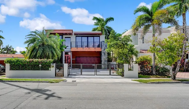 a bed sitting in a bedroom next to a large window