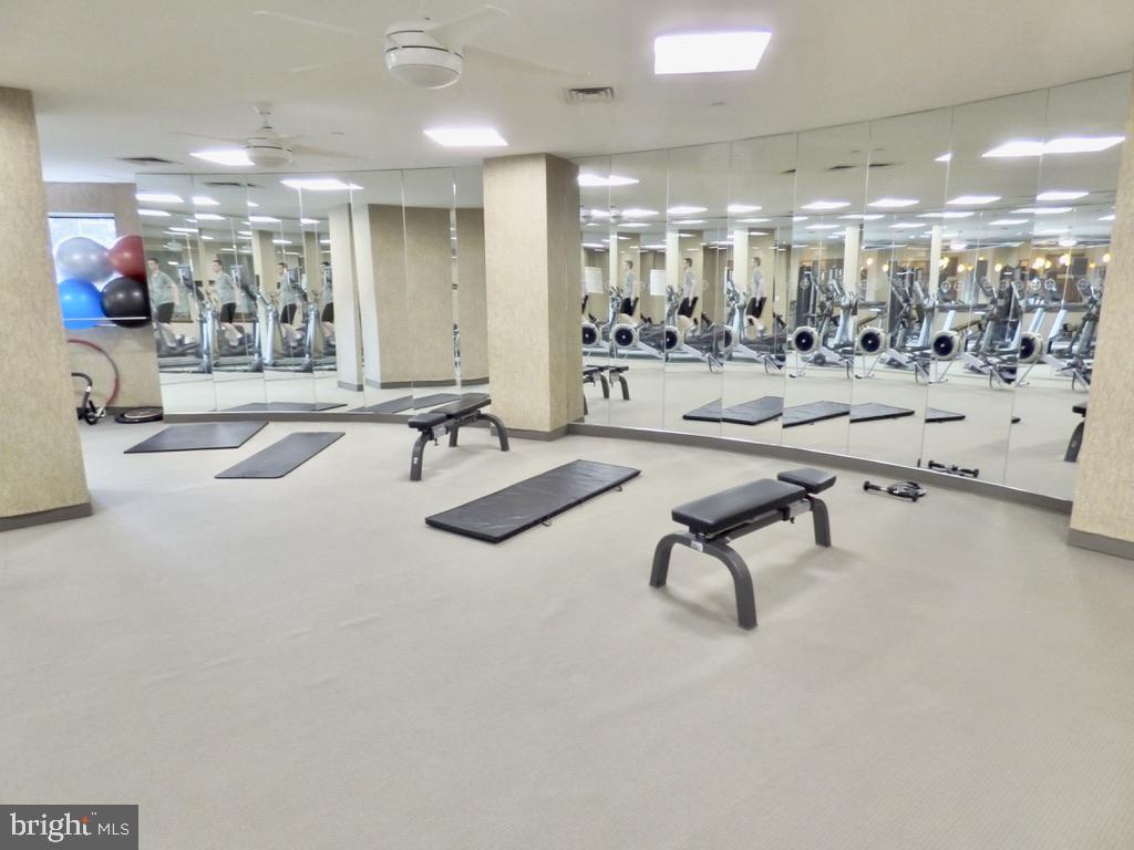 11800 Sunset Hills Road, Unit 118 Reston, VA 20190 - Photo 35 of 52 Modern fitness space with mirrored walls.