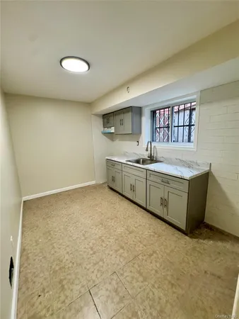a kitchen with a sink and cabinets