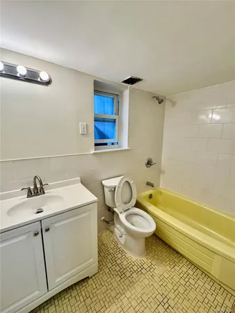 a bathroom with a sink toilet a mirror and shower