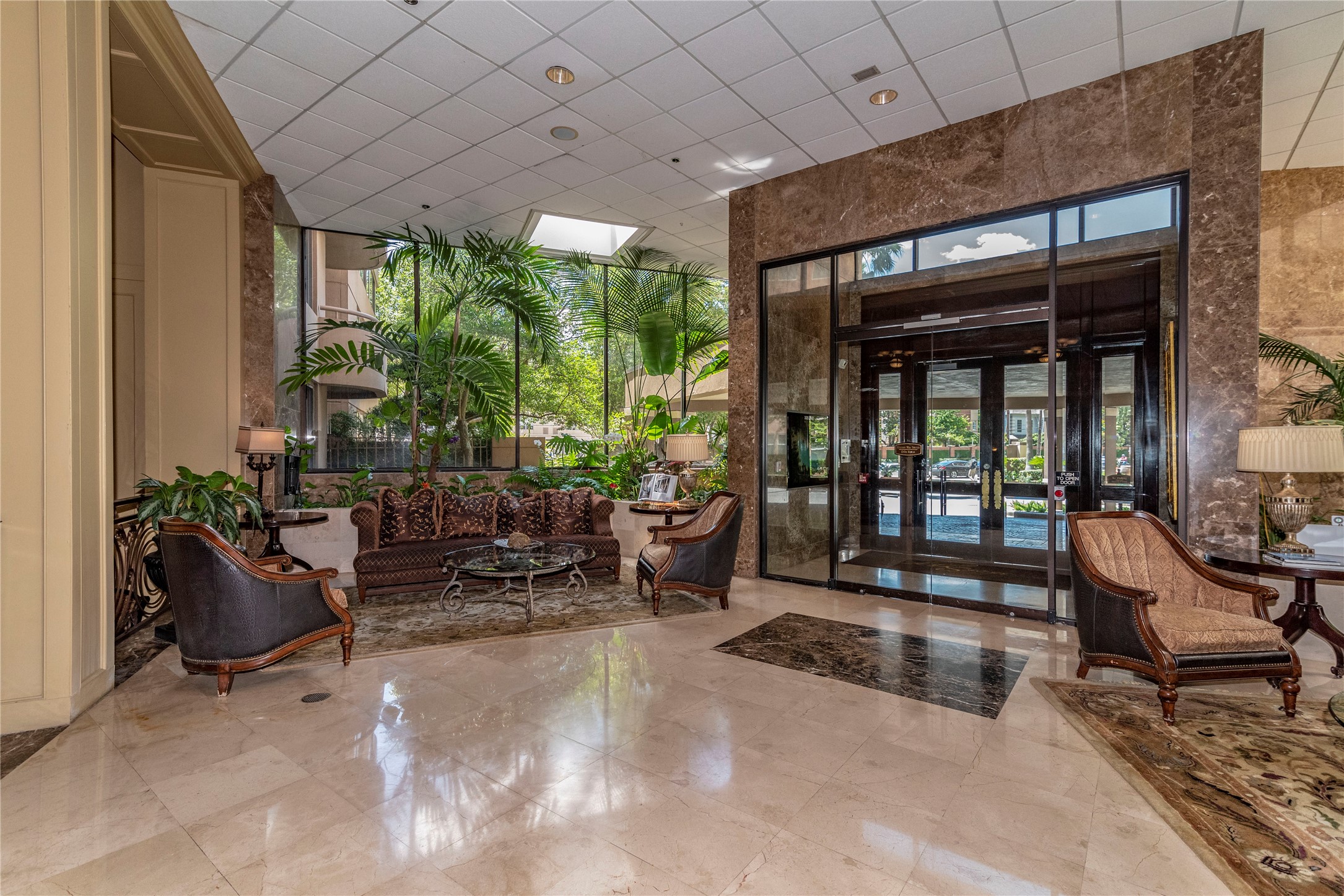 a building outdoor space with patio furniture and potted plants