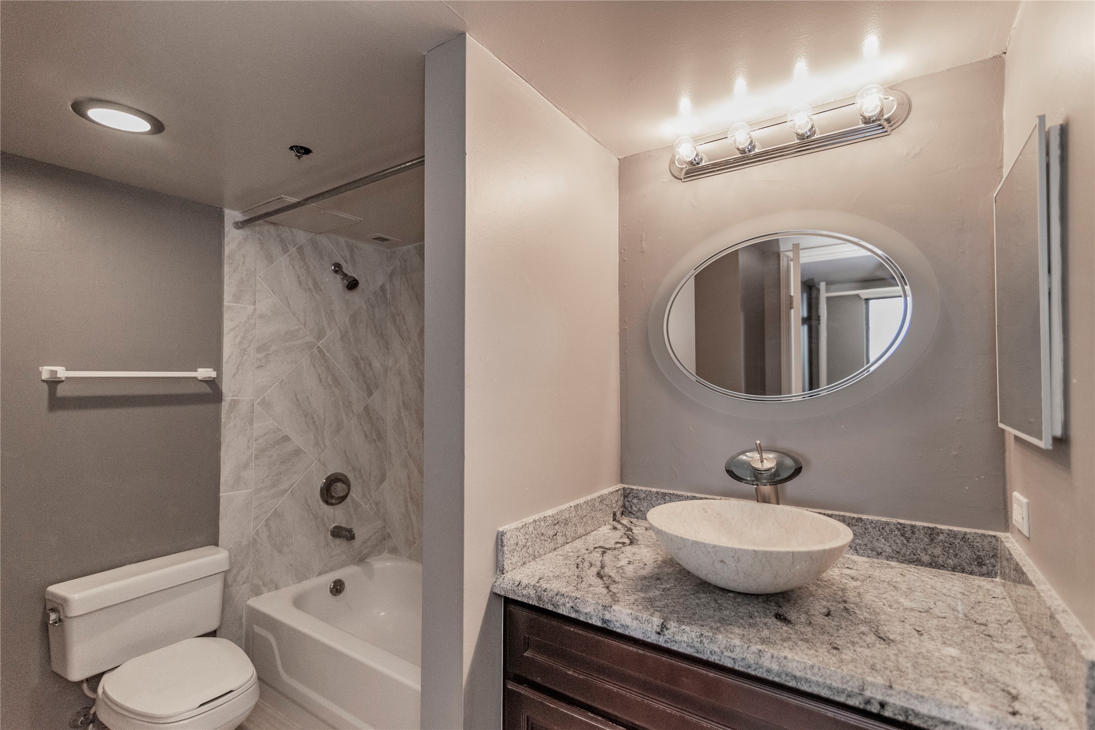 3525 Sage Road, Unit 1402 Houston, TX 77056 - Photo 15 of 19 a bathroom with a granite countertop sink toilet a mirror and shower