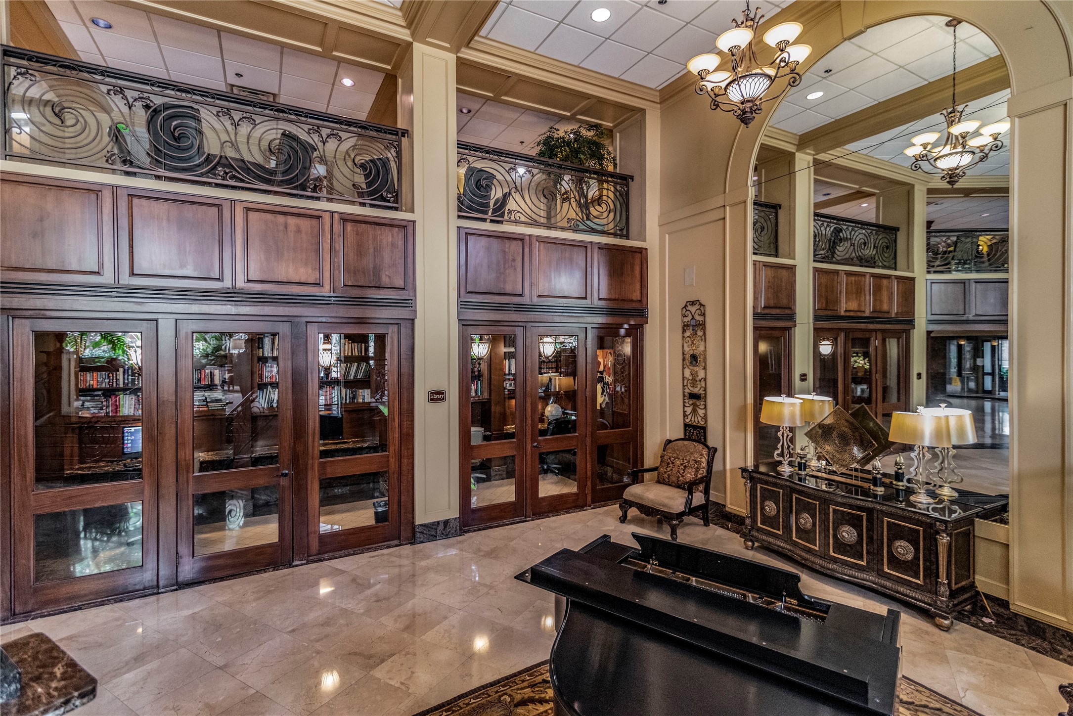 3525 Sage Road, Unit 1402 Houston, TX 77056 - Photo 2 of 19 a room with lots of wooden furniture and a chandelier