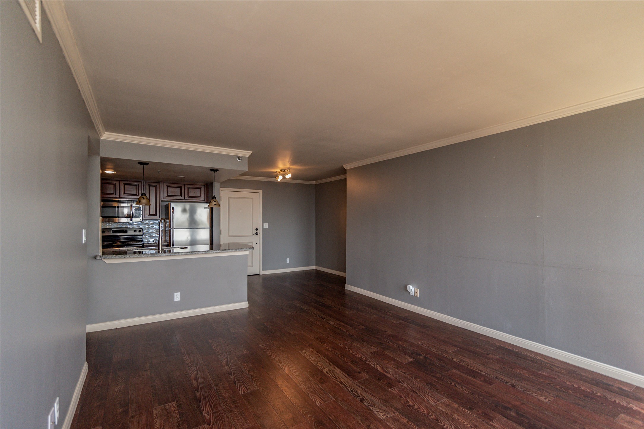 3525 Sage Road, Unit 1402 Houston, TX 77056 - Photo 7 of 19 an empty room with wooden floor and windows