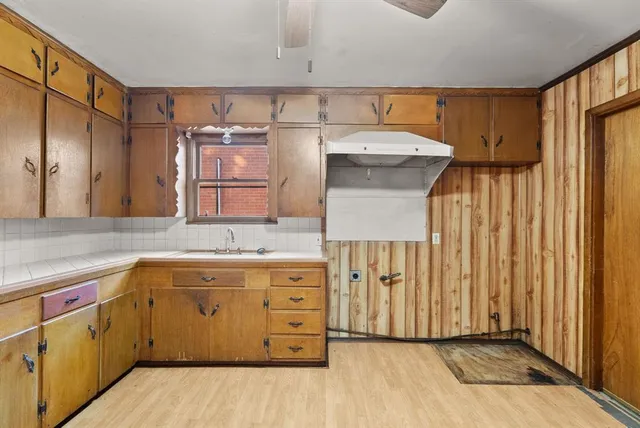 a kitchen with a sink and cabinets