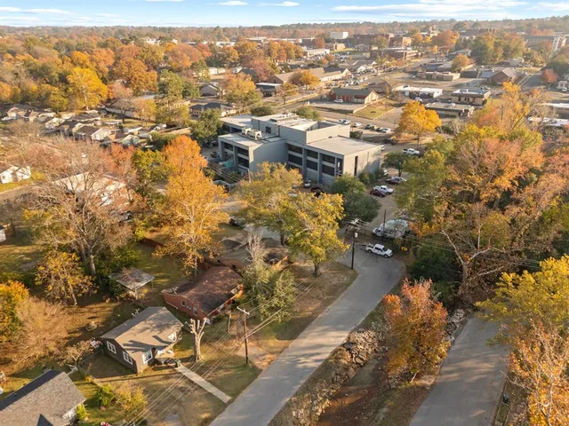 an aerial view of residential houses with city view