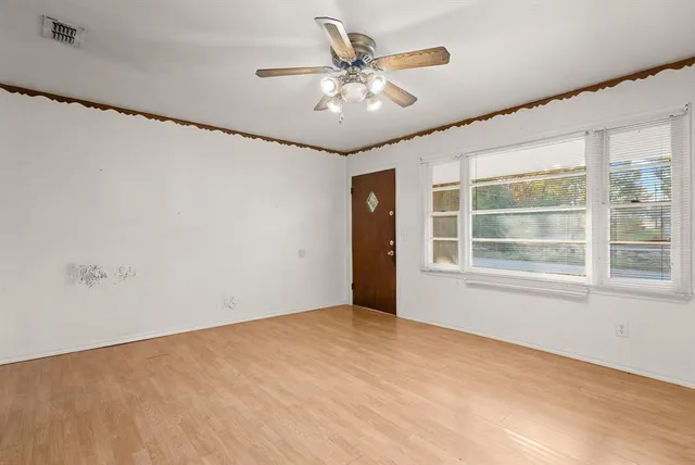 a view of an empty room with a window
