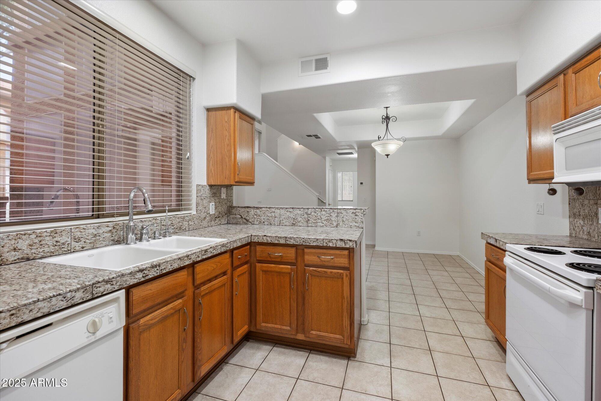 1445 East Broadway Road, Unit 120 Tempe, AZ 85282 - Photo 10 of 39 a kitchen with a sink stove and cabinets