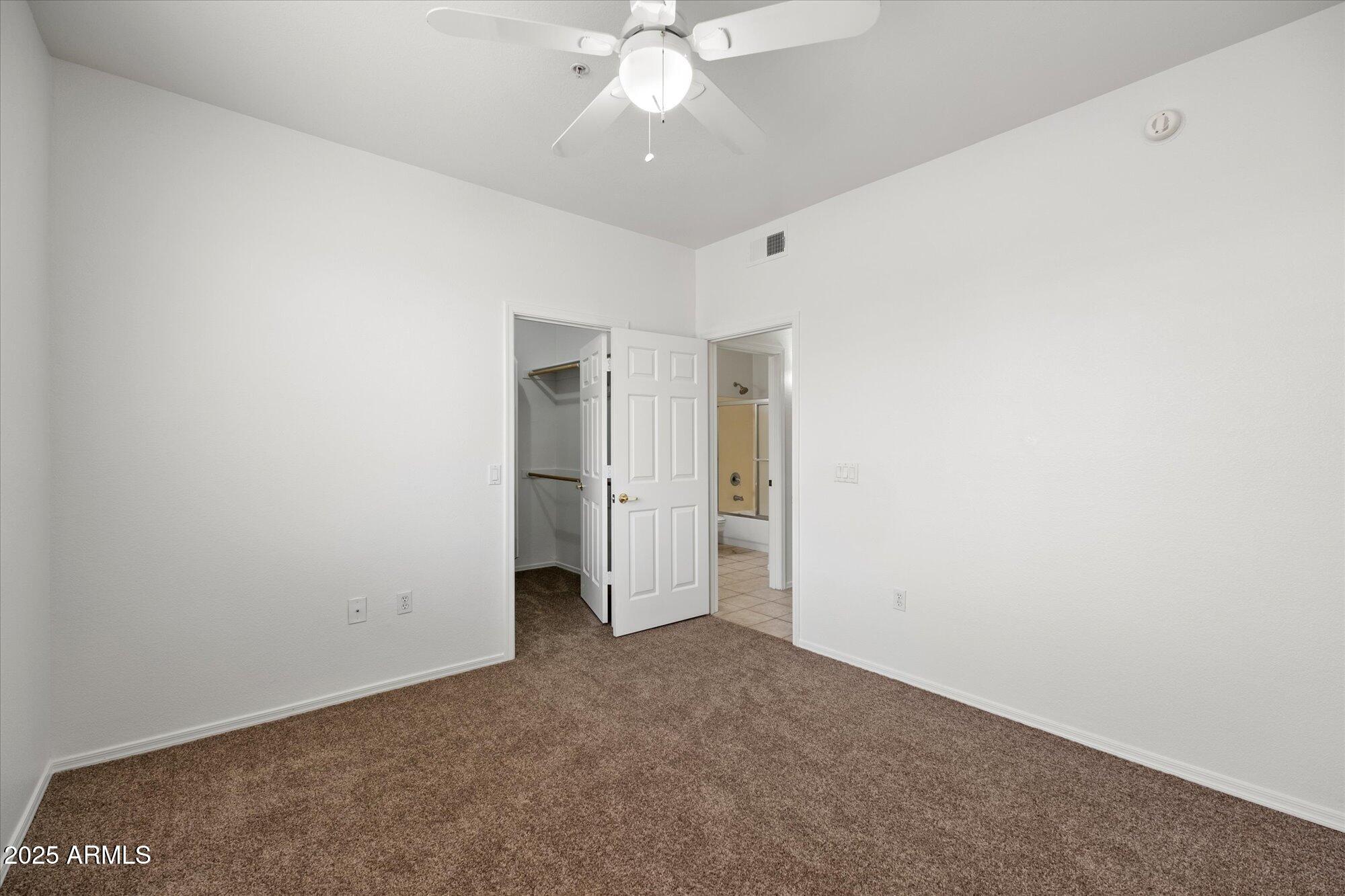 1445 East Broadway Road, Unit 120 Tempe, AZ 85282 - Photo 11 of 39 an empty room with a ceiling fan and entryway