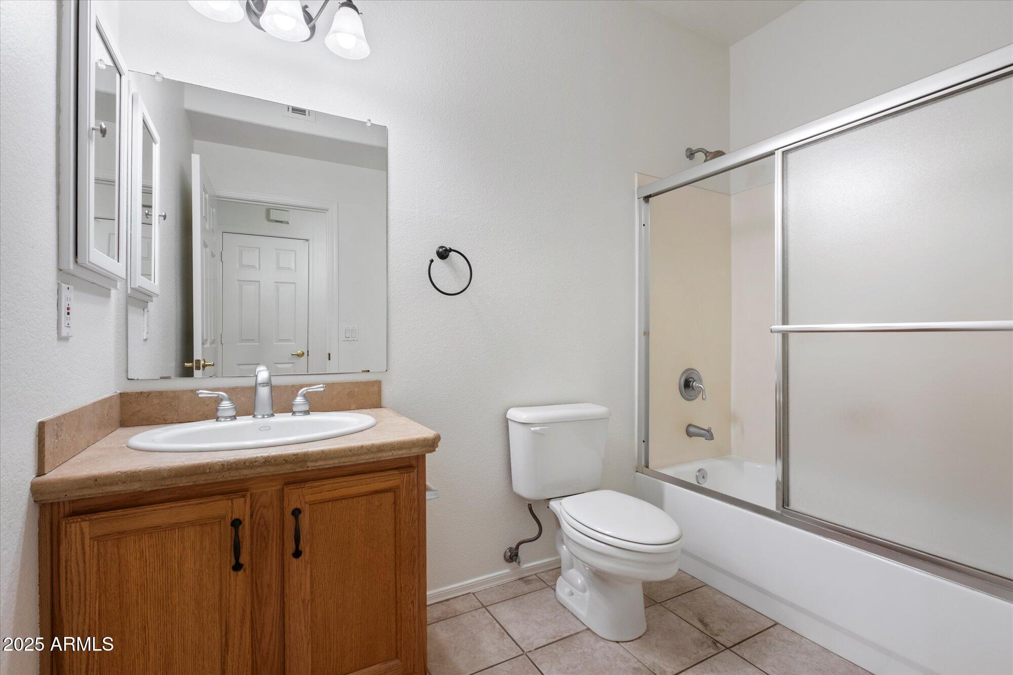 1445 East Broadway Road, Unit 120 Tempe, AZ 85282 - Photo 13 of 39 a bathroom with a toilet a sink and a mirror