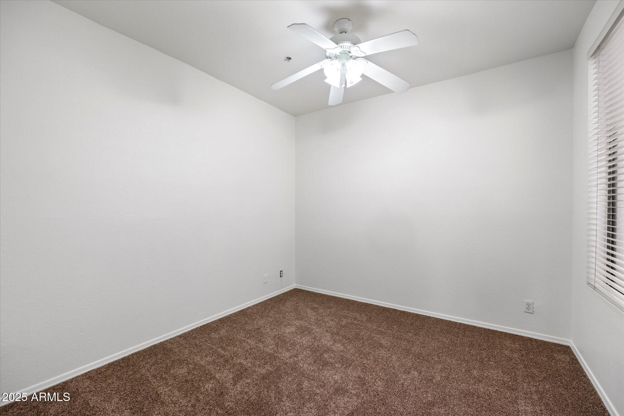 1445 East Broadway Road, Unit 120 Tempe, AZ 85282 - Photo 17 of 39 an empty room with a window and a fan