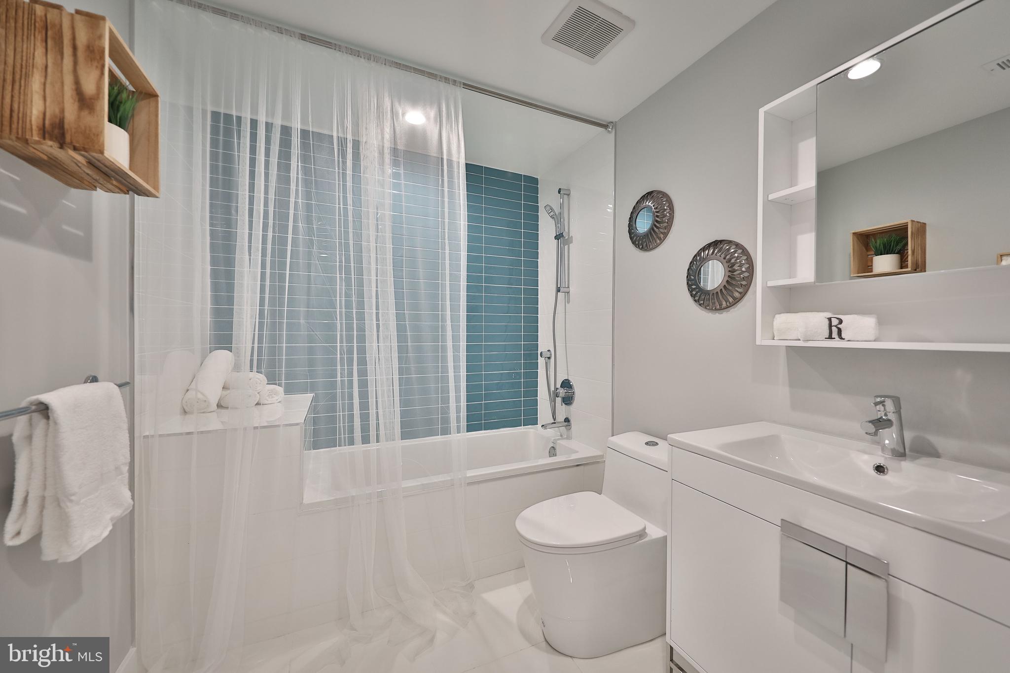 1540-42 Ridge Avenue, Unit 2S Philadelphia, PA 19130 - Photo 16 of 20 a bathroom with a toilet sink and mirror