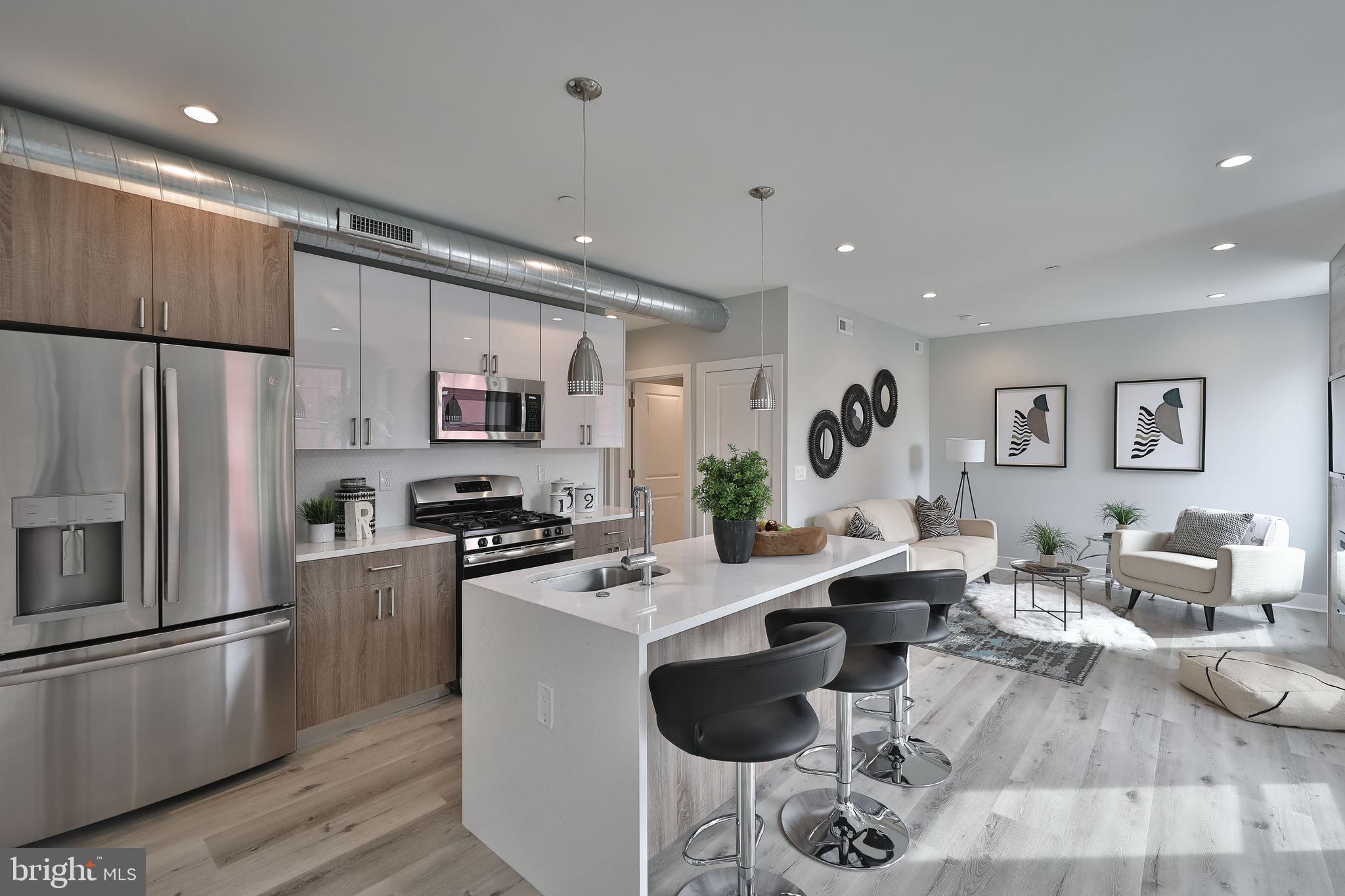 1540-42 Ridge Avenue, Unit 2S Philadelphia, PA 19130 - Photo 2 of 20 a living room with stainless steel appliances furniture or kitchen view and a refrigerator