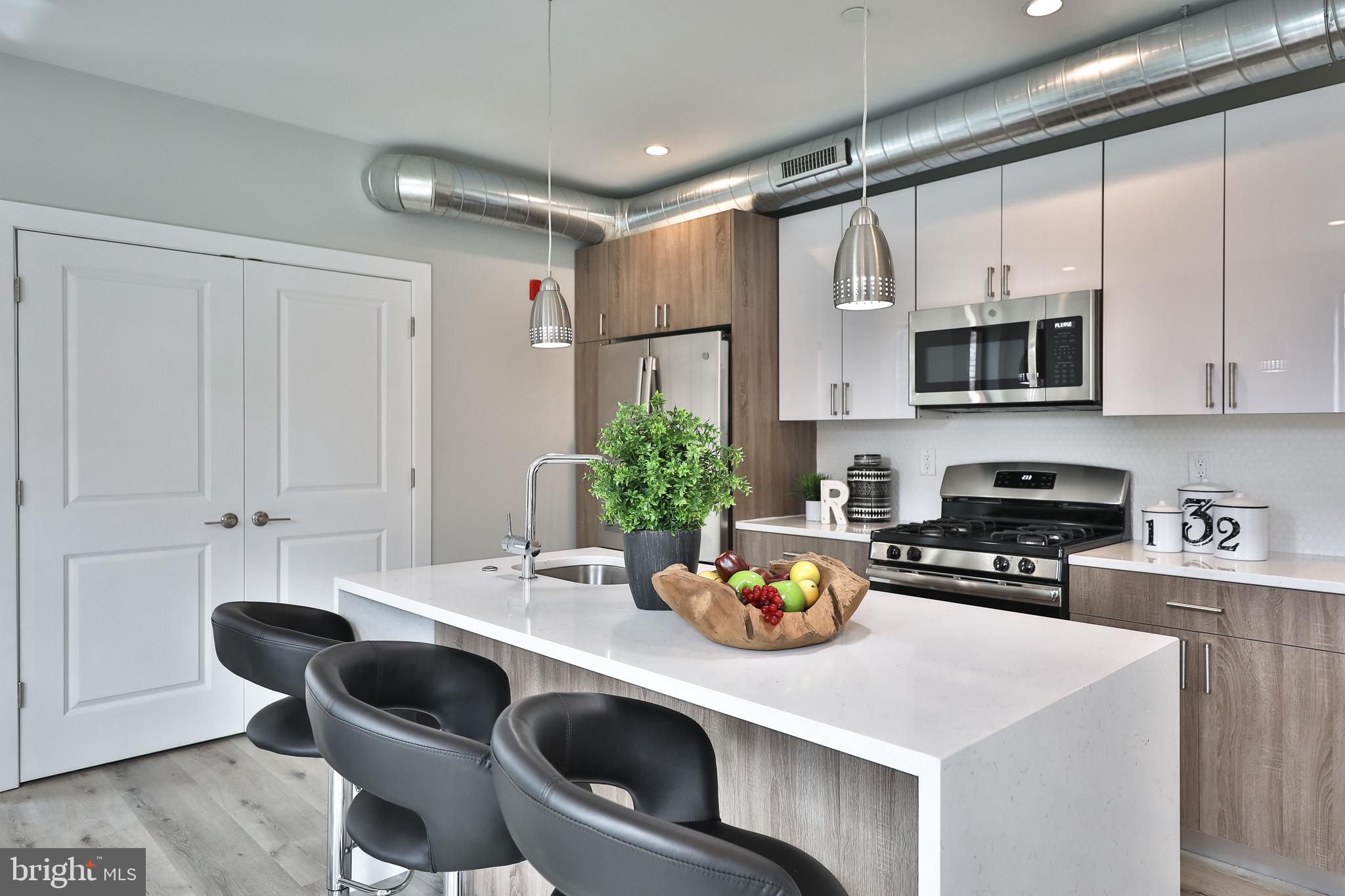 1540-42 Ridge Avenue, Unit 2S Philadelphia, PA 19130 - Photo 5 of 20 a kitchen with a dining table and chairs