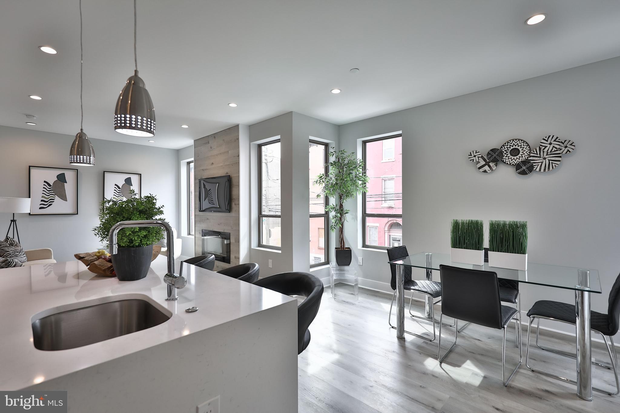 1540-42 Ridge Avenue, Unit 2S Philadelphia, PA 19130 - Photo 7 of 20 a kitchen with a table chairs refrigerator and couch