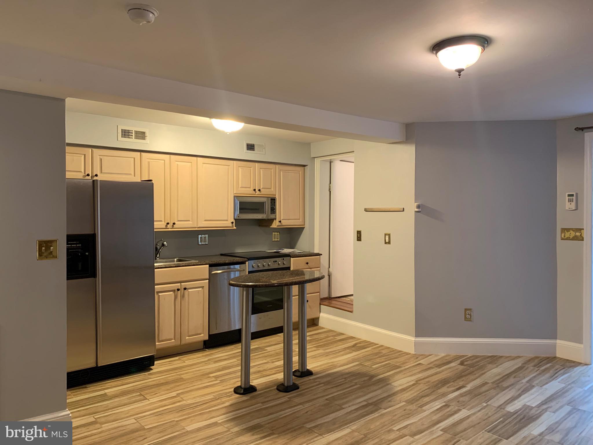 643 E Street Northeast Washington, DC 20002 - Photo 4 of 59 a kitchen with stainless steel appliances a refrigerator and wooden floor