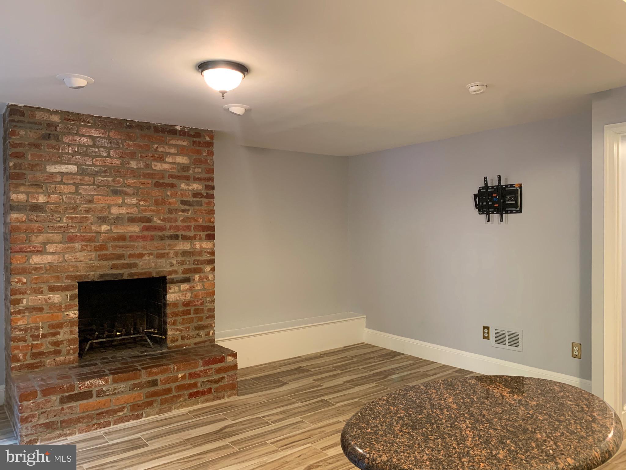 643 E Street Northeast Washington, DC 20002 - Photo 5 of 59 a view of empty room with wooden floor and fireplace