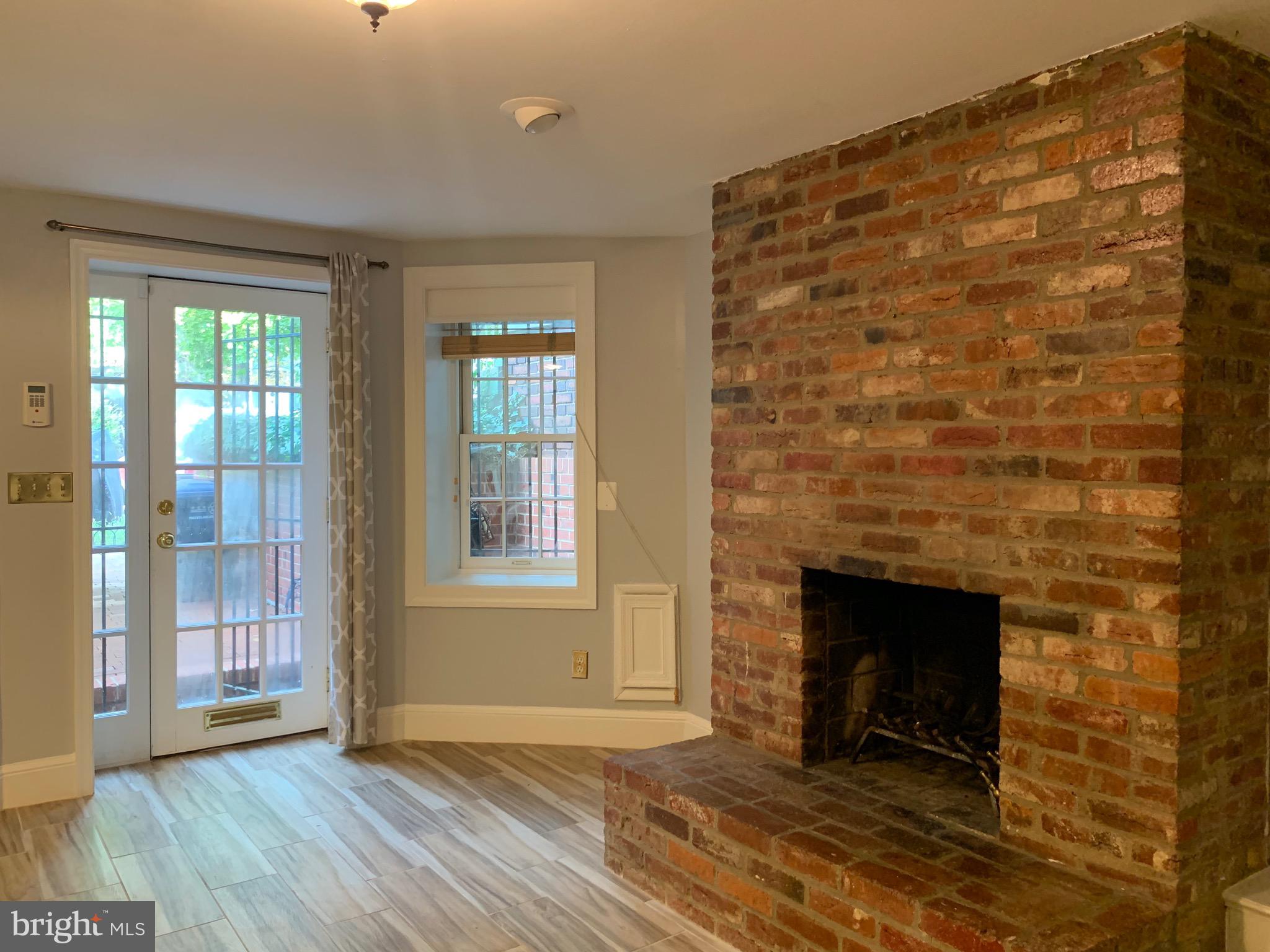 643 E Street Northeast Washington, DC 20002 - Photo 6 of 59 a view of an empty room with wooden floor and a fireplace