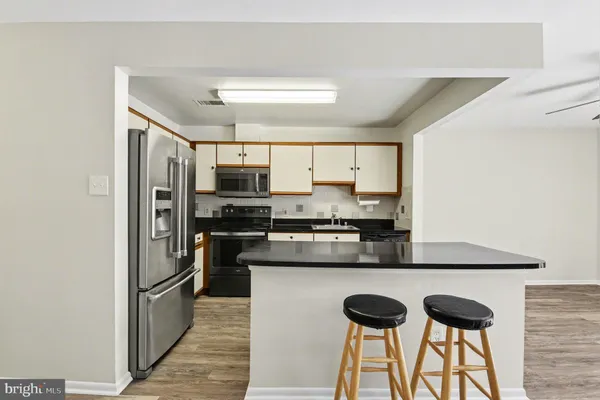 a kitchen with stainless steel appliances a sink cabinets and a counter top space