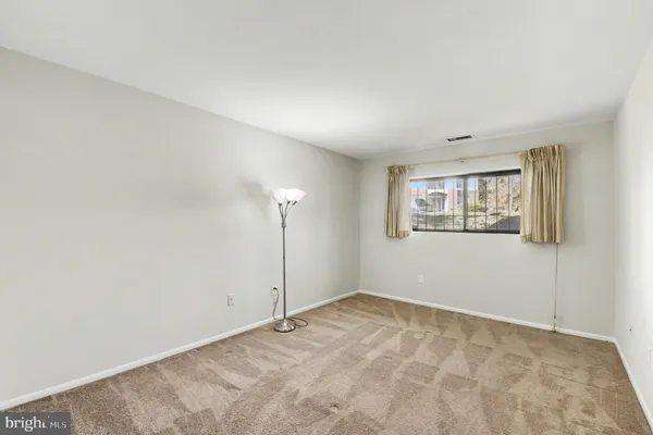 a bathroom with a bathtub shower sink vanity mirror and toilet