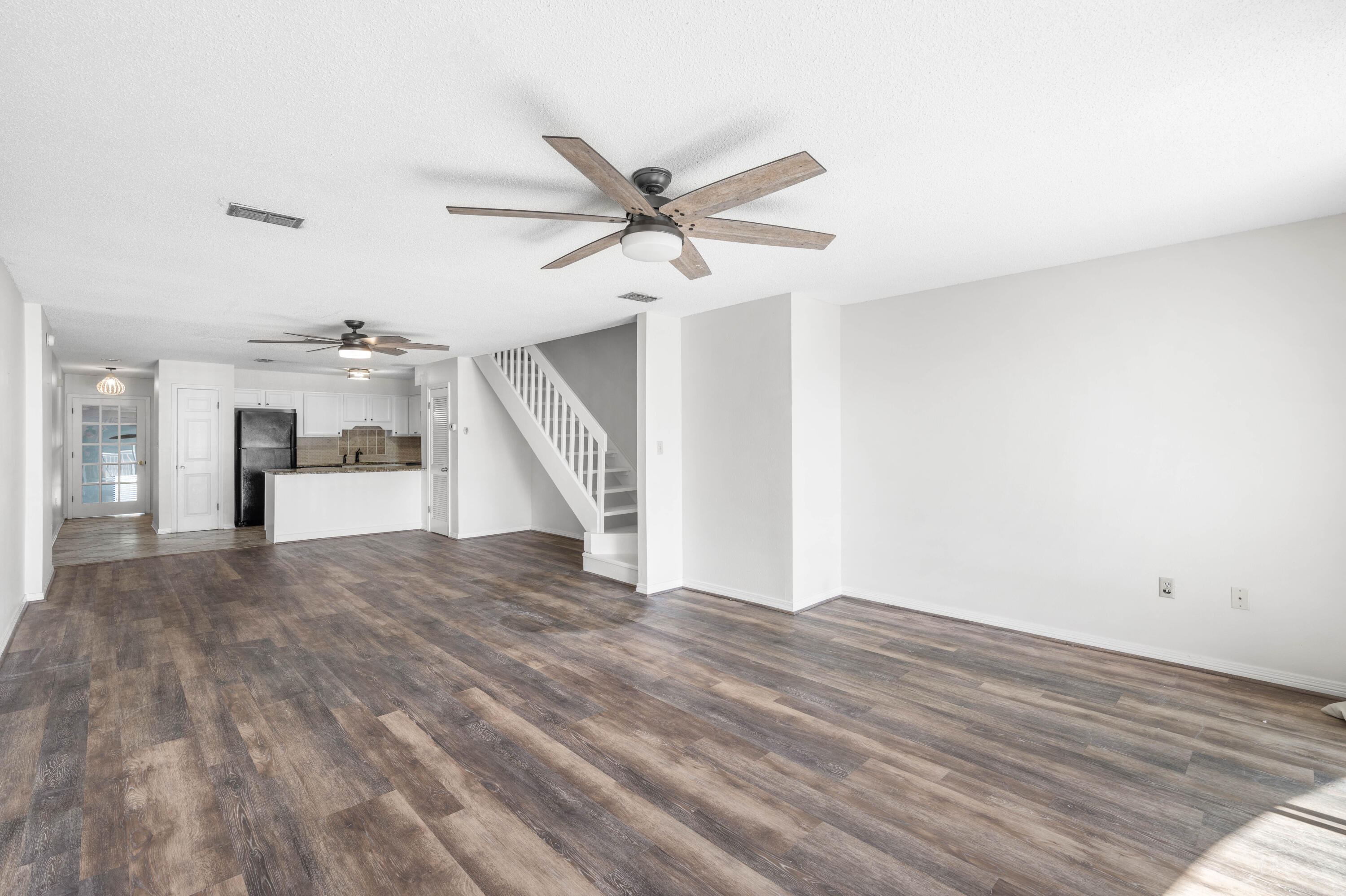 3654 East County Highway 30A, Unit 8B Santa Rosa Beach, FL 32459 - Photo 11 of 42 a view of a livingroom with a ceiling fan window and stairs