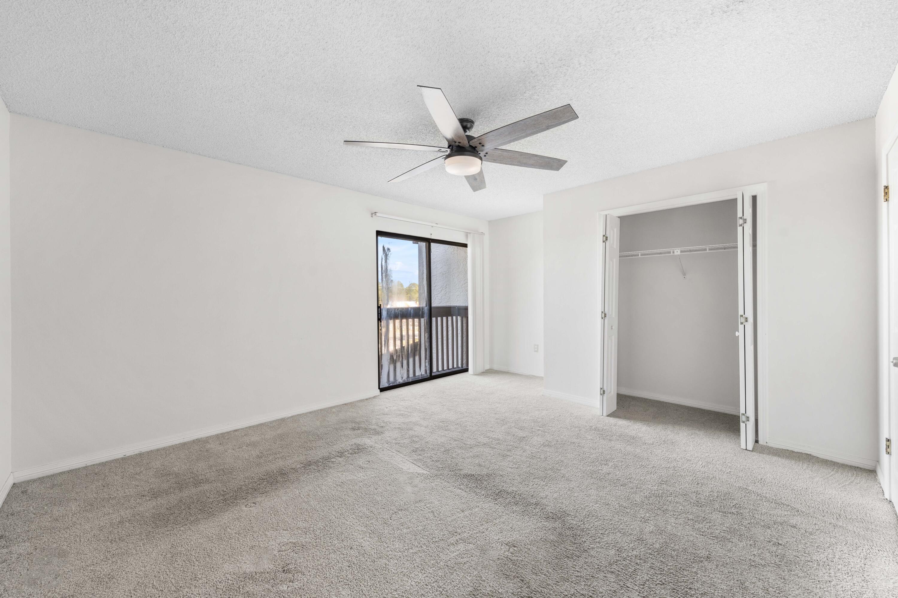 3654 East County Highway 30A, Unit 8B Santa Rosa Beach, FL 32459 - Photo 18 of 42 an empty room with chandelier fan and windows