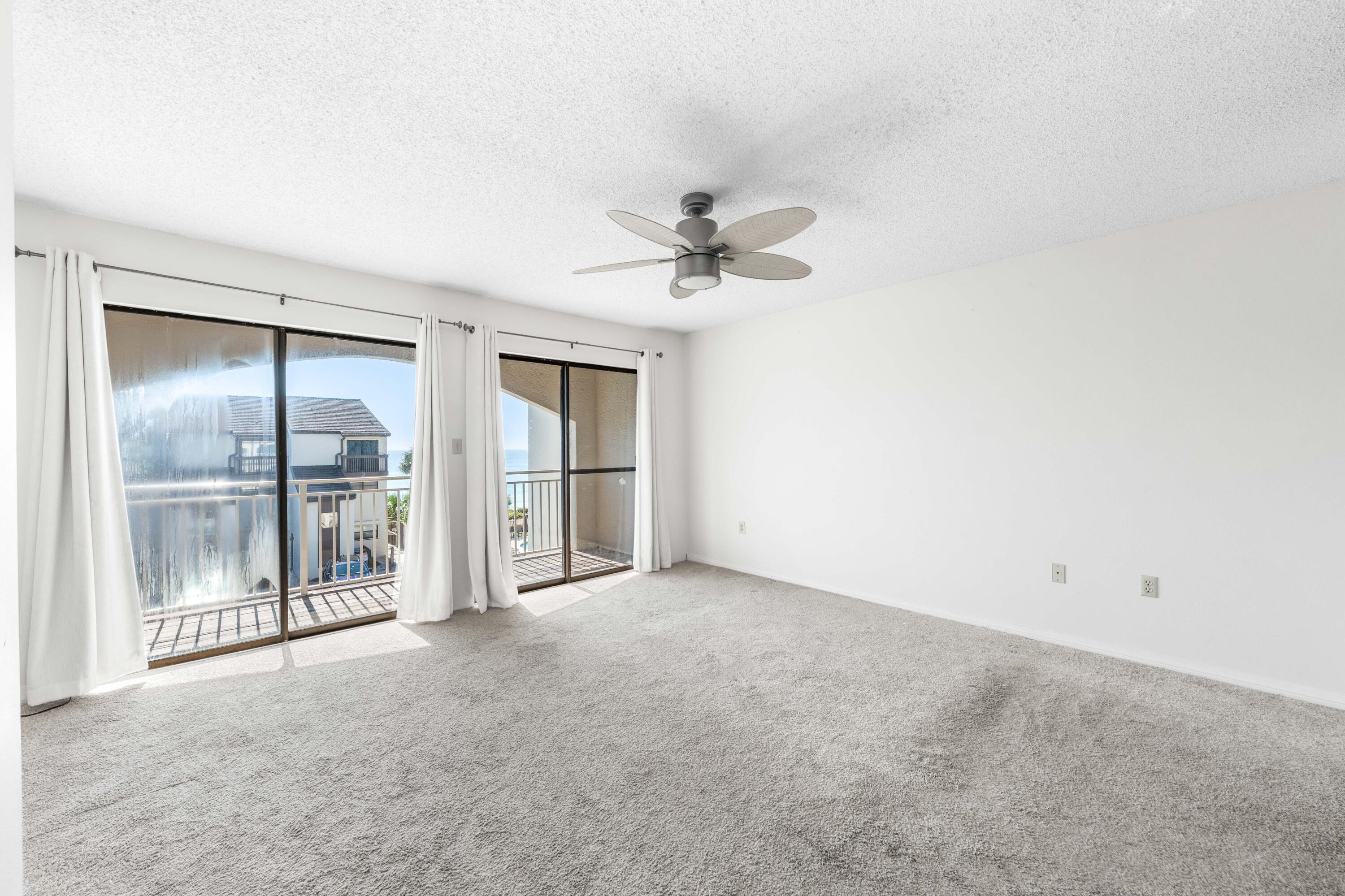 3654 East County Highway 30A, Unit 8B Santa Rosa Beach, FL 32459 - Photo 24 of 42 an empty room with a ceiling fan and a window