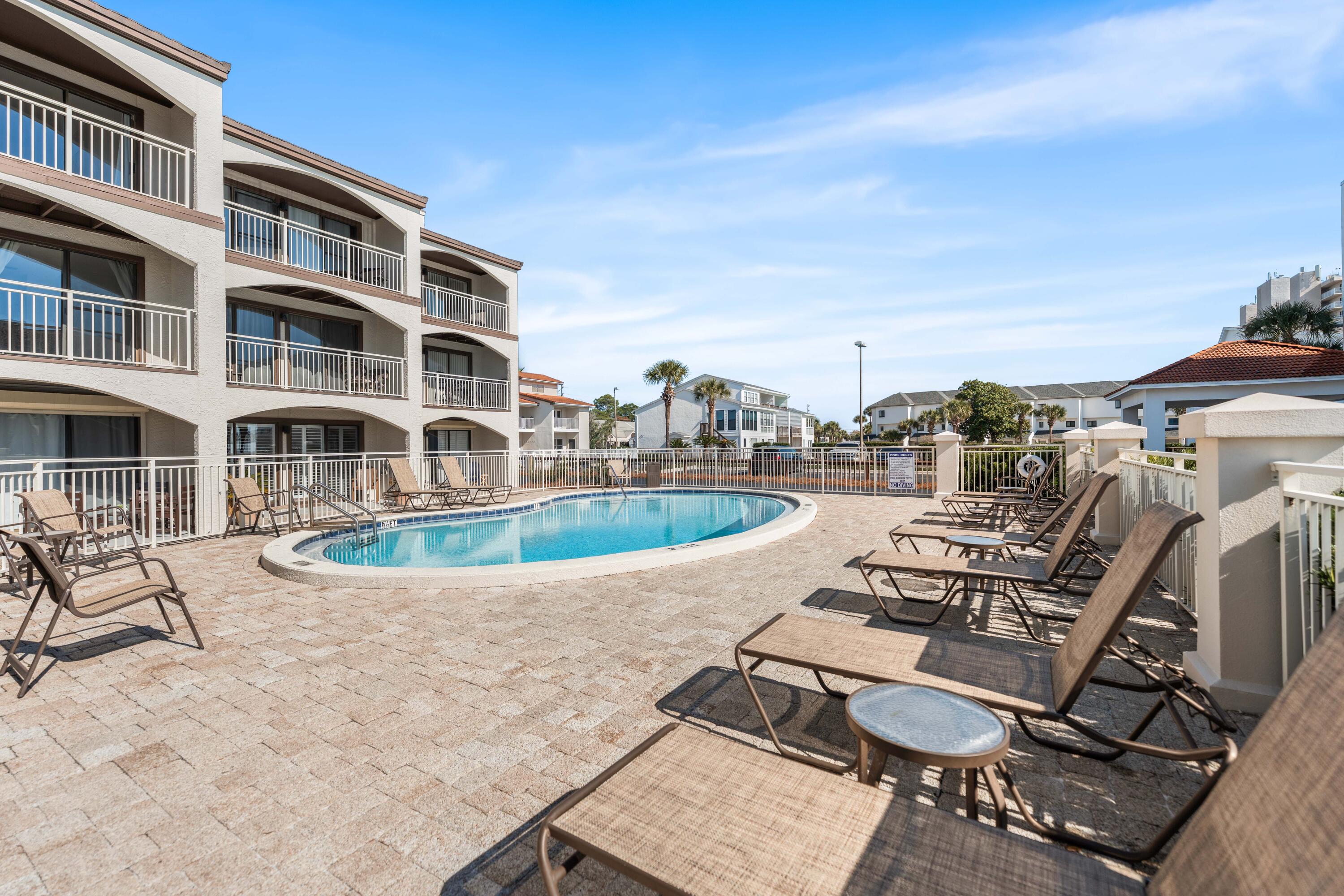 3654 East County Highway 30A, Unit 8B Santa Rosa Beach, FL 32459 - Photo 35 of 42 a view of a swimming pool with chairs
