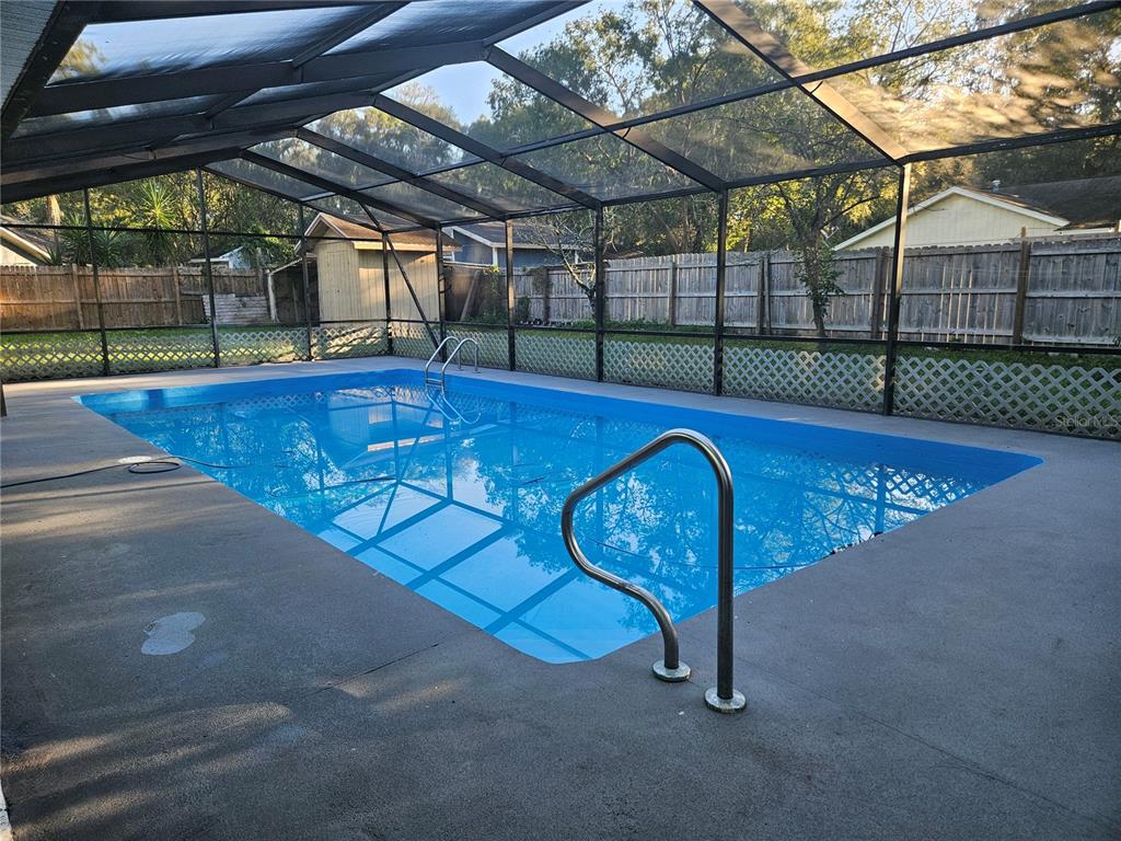 985 Southeast 56th Court Ocala, FL 34480 - Photo 33 of 36 a view of a swimming pool with a porch