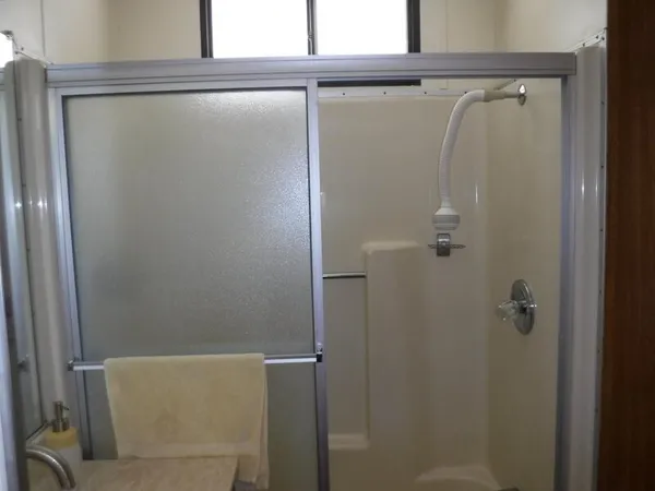 a bathroom with a shower and a mirror