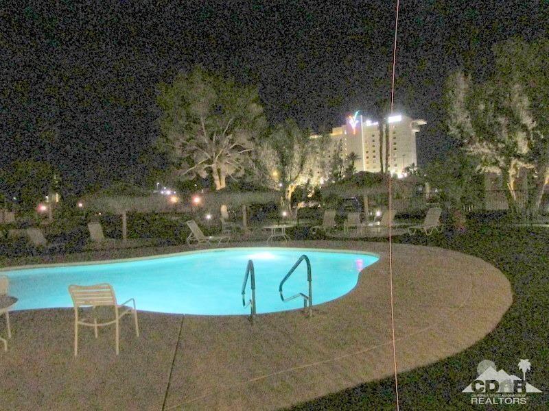 84250 Indio Springs Drive, Unit 422 Indio, CA 92203 - Photo 19 of 23 a swimming pool with outdoor seating and yard