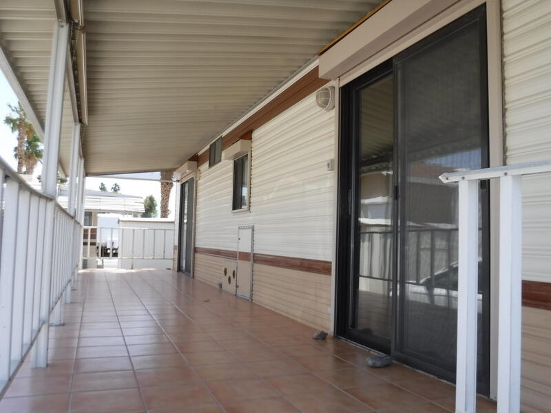 84250 Indio Springs Drive, Unit 422 Indio, CA 92203 - Photo 21 of 23 a view of a porch with a table and chairs