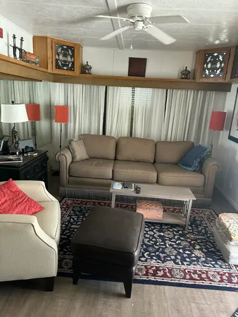 a living room with furniture a rug and a flat screen tv