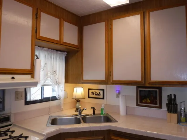 a kitchen with stainless steel appliances granite countertop a sink and cabinets