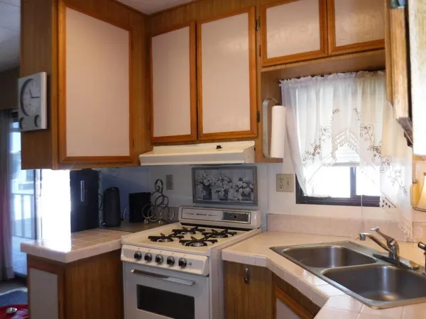 a kitchen with stainless steel appliances a stove and a microwave