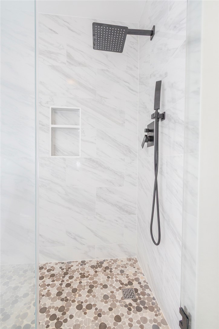 230 Hammond Circle Anderson, SC 29621 - Photo 35 of 48 This sleek shower features modern fixtures and exquisite tile work, creating a serene bathing experience.
