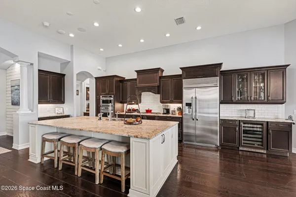 a kitchen with stainless steel appliances granite countertop a stove and refrigerator