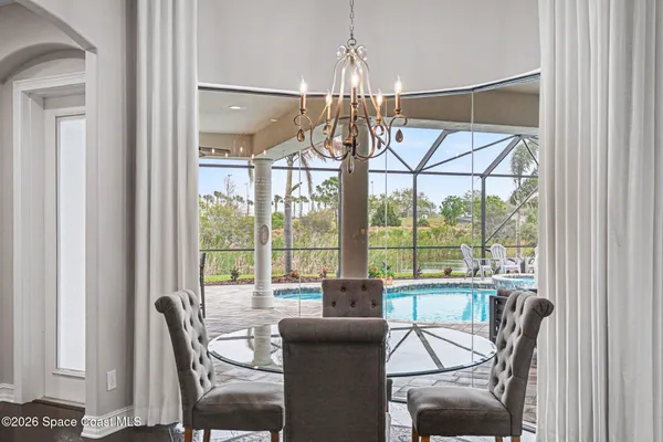 a view of a dining room with furniture wooden floor and chandelier