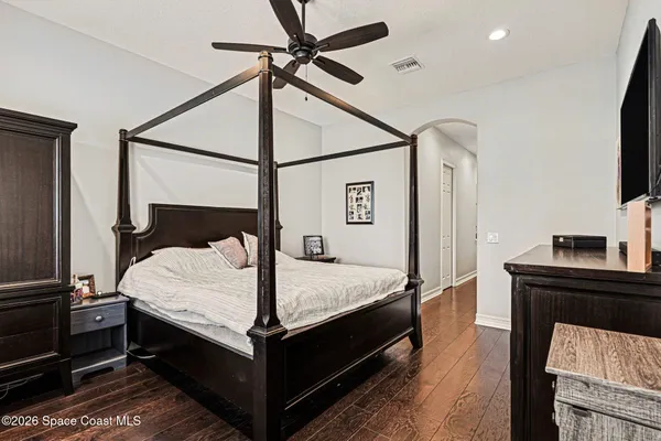 a bed sitting in a bedroom next to a window