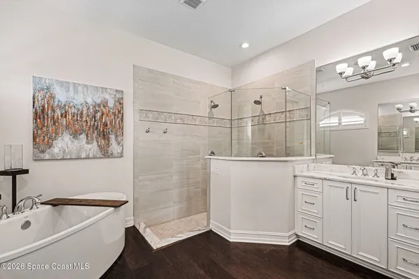 a bathroom with a tub sink and mirror