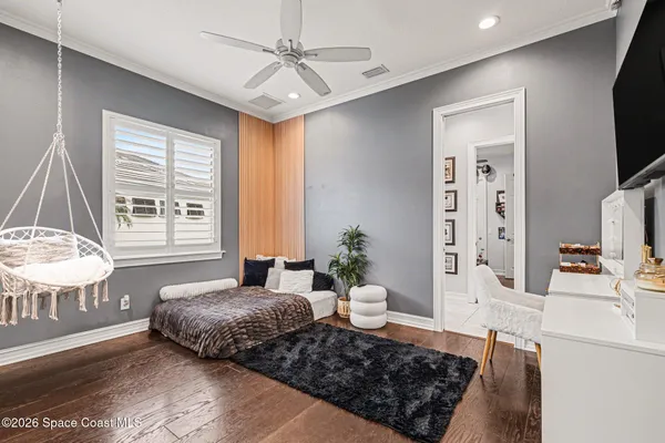 a bedroom with a bed a large window and flat screen tv