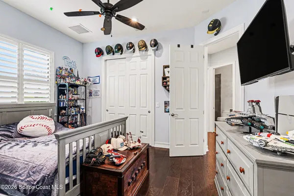 a bedroom with furniture and a flat screen tv