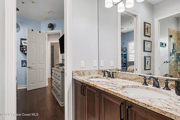 a bathroom with a granite countertop sink and a mirror