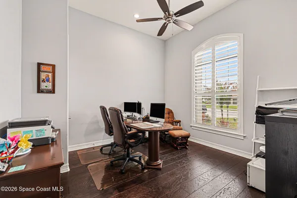 a view of a workspace with furniture and a window