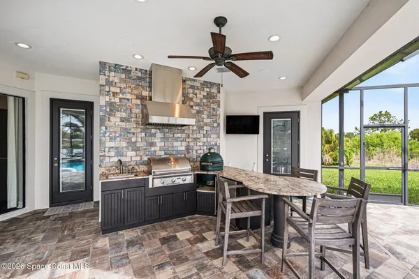 a kitchen with stainless steel appliances granite countertop a sink and a table
