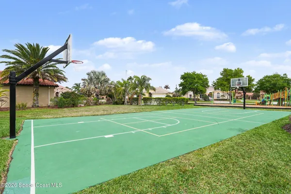 a view of a playground and basketball court