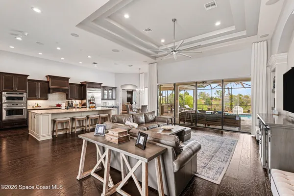a living room with lots of furniture and kitchen view