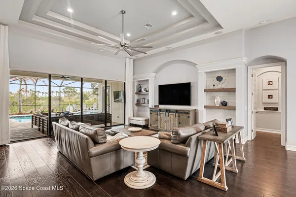a living room with furniture wooden floor and a flat screen tv