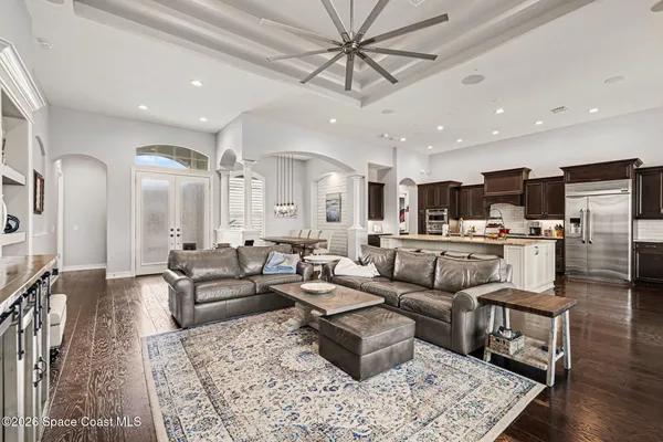 a living room with furniture and kitchen view