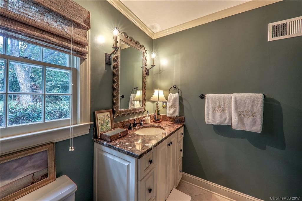 3214 Colony Road Charlotte, NC 28211 - Photo 12 of 24 a bathroom with a sink and a mirror